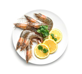 Plate with fresh shrimps and slices of lemon on white background