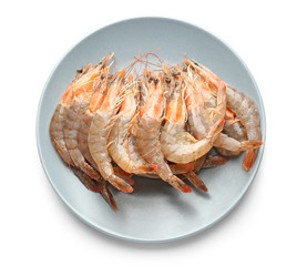 Plate with fresh shrimps on white background