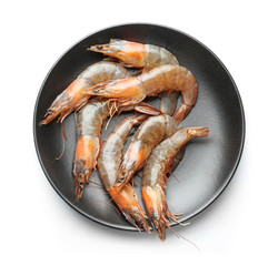 Plate with fresh shrimps on white background