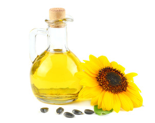 Sunflower oil in glass jug, seeds and flower isolated on white background