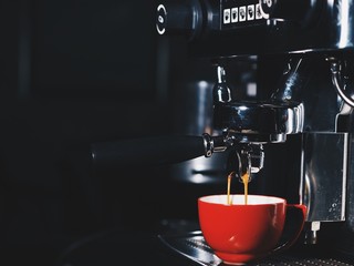 Coffee machine making espresso shot.