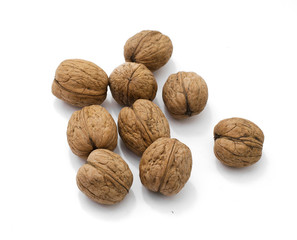 several walnuts in shell on white background