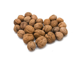 Nuts lie in the shape of heart on a white background