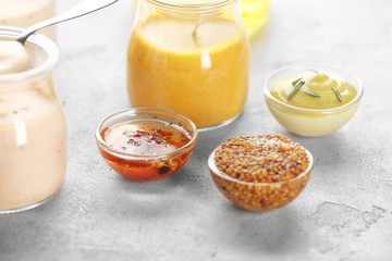 Gravy boats with sauces for salad on table