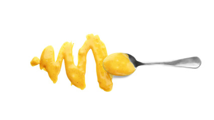 Spoon with tasty sauce for salad on white background