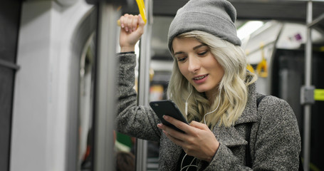 Girl on her phone while travelling on the bus
