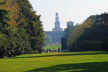 Sights of Italy. Castello-Sforzesco in a quiet green park. Sforza Castle in sunny weather. Park in the center of Milan.