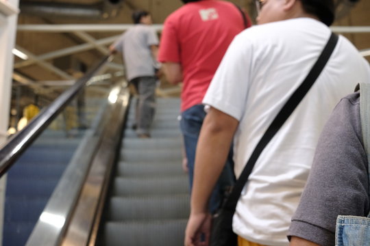 blur picture background  of  people is shopping  and line up on escalator   in  furniture mall .