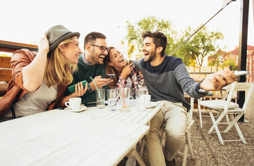Group of people at cafe talking laughing and enjoying their time