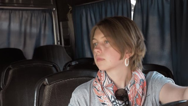 Young woman setas in the bus