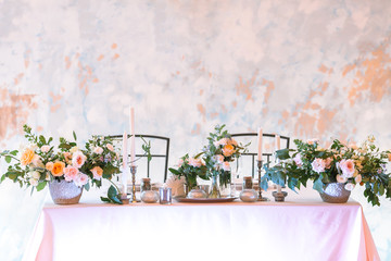 romance, dating, table setting concept. the most perfect table setting for romantic evening for couple, plenty of flowers in big and tiny bunches, numbers of candles in various holders and dishes