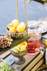 small business, creating, vegetarian concept. close up of fresh mellow fruits and nuts on the dark colored wooden shelves of grocery shop, where everybody can buy some confection or drink