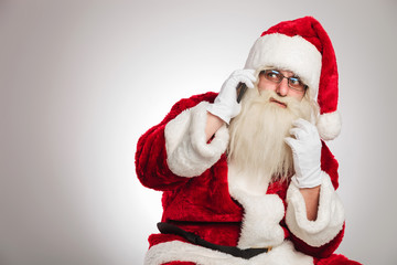 santa talking on phone looks to side