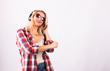 Fototapeta premium Happy pretty woman having fun with headphones against white background.