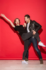 Full length image of cheerful punk couple dancing together