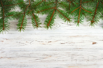 Christmas wooden background with fir tree and snow. View with copy space for your text