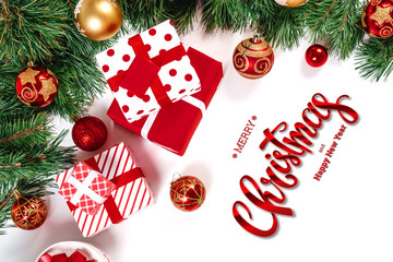 The inscription of Merry Christmas and Happy New Year, green spruce, toys and gifts on a white background. Christmas card, festive background. Mixed media.