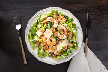 Overhead photo of shrimp Caesar salad with copyspace