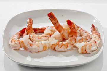 Jumbo Head Less Cooked prawns on white plate on white background