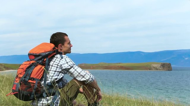 Man relaxing with serene view of lake Baikal. landscape Travel Lifestyle hiking concept summer vacations outdoor