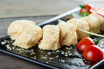 Close up of cheese rolls with sezam on a black plate served with cherry tomatoes copyspace restaurant menu delicious food eating appetizer hunger appetite cafe concept.