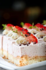 Vertical shot of a freshly baked cheesecake with sliced strawberries on top and chocolate crust decorations copyspace dessert sweet food delicious eating breakfast restaurant concept.