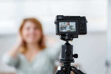Blurred image of florist woman at table with florarium.