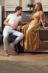 Image of loving couple in kitchen with juice