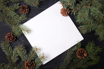 Christmas gifts shopping planning. Make a shopping list for Christmas. Notebook on the wooden background with New Year's decor.