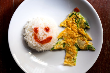Omelet with green onion and rice in the form of a Christmas tree and snowman