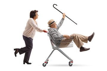 Young woman holding a shopping cart filled with groceries