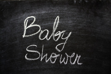 Fototapeta na wymiar Baby Shower Announcement On Black Chalkboard
