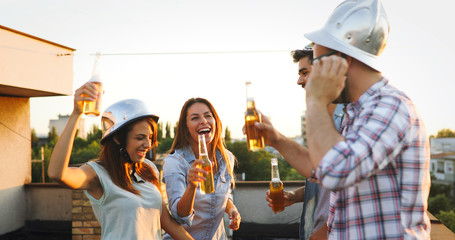 Group of happy friends having party on rooftop