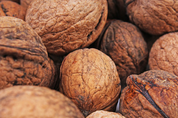 Walnut texture. Brown big walnuts as background. walnut nuts pattern close up photo. Walnuts with shells.