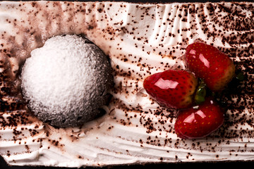 Slice of fruit Christmas cake with fresh strawberry