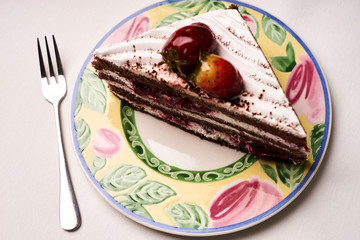 Slice of fruit Christmas cake with fresh strawberry