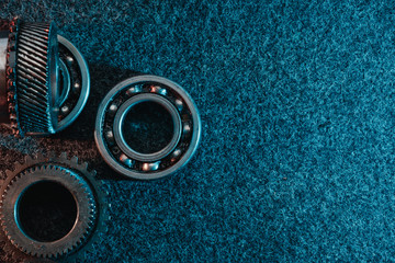 Gears and bearings on a dark background. Top view, flat design. Automotive concept.