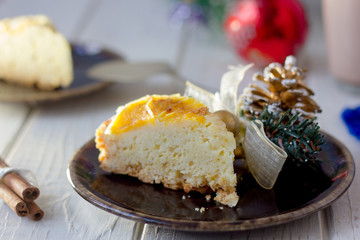 Piece of christmas cake ready to eat on rustic plate.