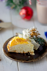 Piece of christmas cake ready to eat on rustic plate.