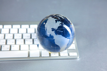 Cristal globe of the Earth on a Computer
