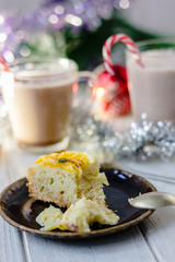 Piece of christmas cake ready to eat on rustic plate.