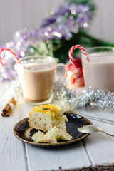 Piece of christmas cake ready to eat on rustic plate.