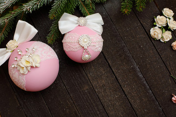 Christmas balls with bows and rhinestones on a wooden background