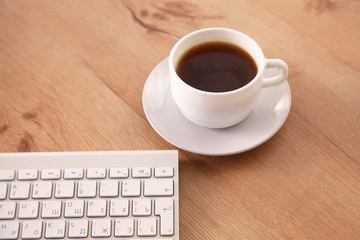 Office table with blank notepad and laptop