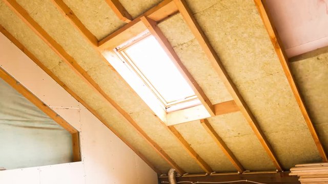 house attic under construction mansard wall insulation with rock wool