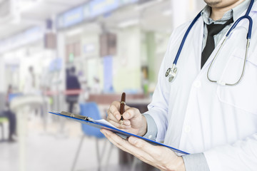 Health care, emergency room physician Writing a patient illness report.