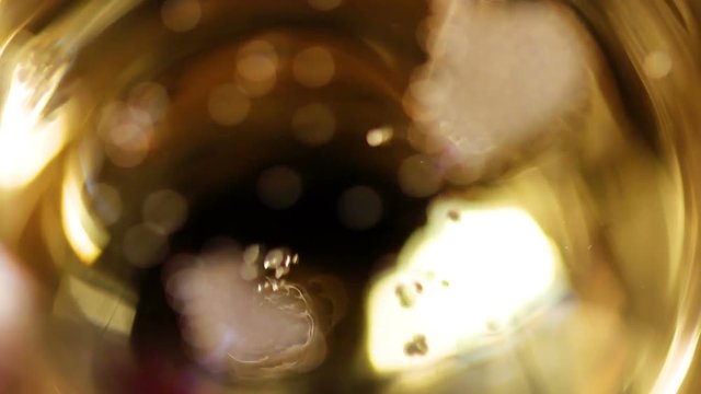 Champagne bubbles in a glass close up macro on dark background.
