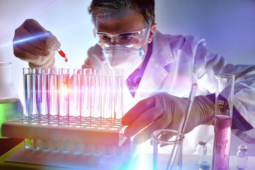 Chemical analyzing different substances in the laboratory with light effects