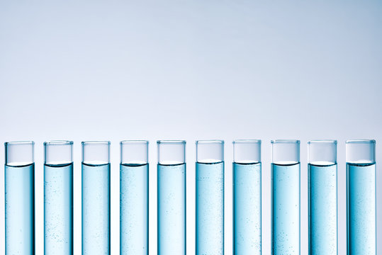 Row of tubes with blue liquid frontal view