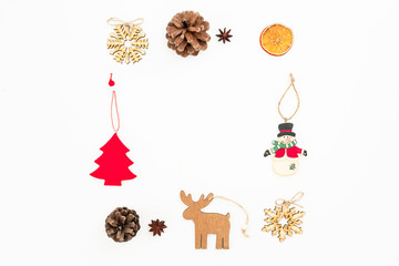 Christmas frame of holiday decoration and pine cones on white. Flat lay, top view. New Year frame concept